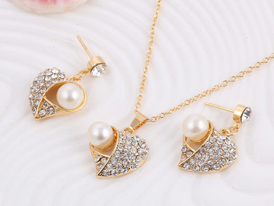 Gold-toned heart-shaped necklace and dangle earrings set with clear rhinestones and faux pearls. - Image 24
