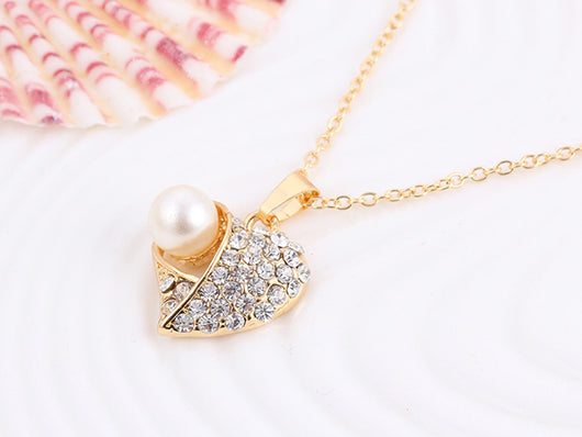 Gold-toned heart-shaped necklace and dangle earrings set with clear rhinestones and faux pearls. - Image 25