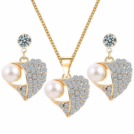 Gold-toned heart-shaped necklace and dangle earrings set with clear rhinestones and faux pearls. - Image 27