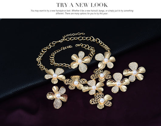Gold-tone four-piece jewelry set with flower motifs, featuring a necklace, bracelet, ring, and earrings, all with faux pearls and clear rhinestones. - Image 9
