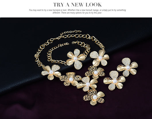 Gold-tone four-piece jewelry set with flower motifs, featuring a necklace, bracelet, ring, and earrings, all with faux pearls and clear rhinestones. - Image 10
