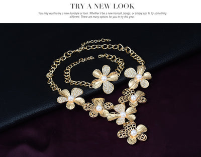 Gold-tone four-piece jewelry set with flower motifs, featuring a necklace, bracelet, ring, and earrings, all with faux pearls and clear rhinestones. - Image 11