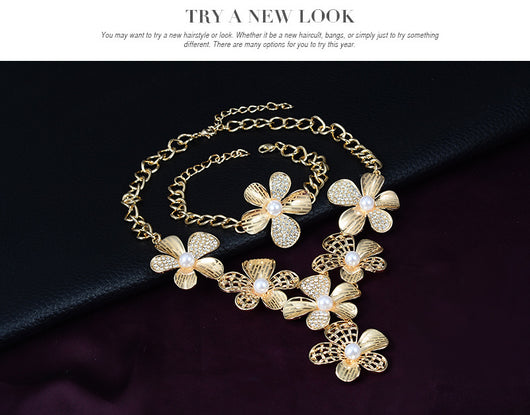 Gold-tone four-piece jewelry set with flower motifs, featuring a necklace, bracelet, ring, and earrings, all with faux pearls and clear rhinestones. - Image 11
