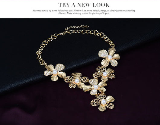 Gold-tone four-piece jewelry set with flower motifs, featuring a necklace, bracelet, ring, and earrings, all with faux pearls and clear rhinestones. - Image 12