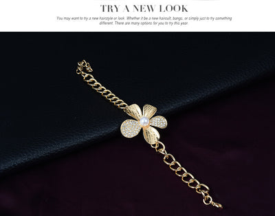 Gold-tone four-piece jewelry set with flower motifs, featuring a necklace, bracelet, ring, and earrings, all with faux pearls and clear rhinestones. - Image 13