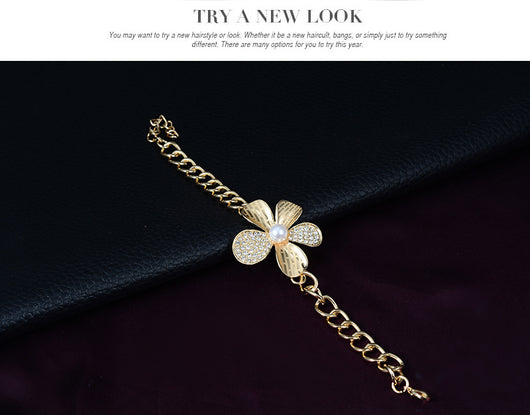 Gold-tone four-piece jewelry set with flower motifs, featuring a necklace, bracelet, ring, and earrings, all with faux pearls and clear rhinestones. - Image 13