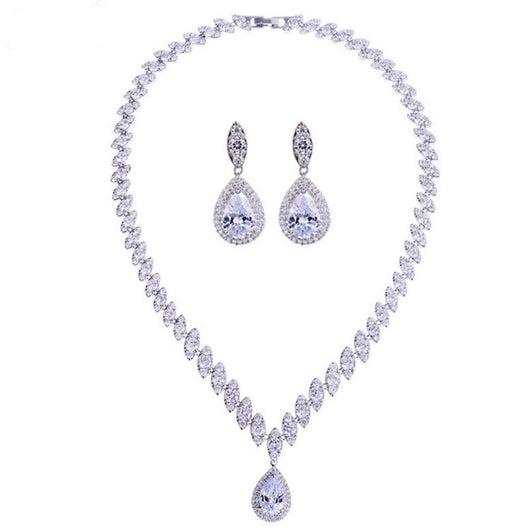 Silver-toned necklace and earring set with red teardrop stones and clear marquise-cut accents on a black display. - Image 14