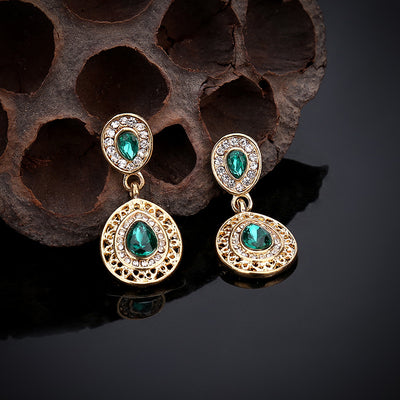 Gold-toned necklace and matching drop earrings set with blue teardrop crystals and clear rhinestones, on a wooden box. - Image 22