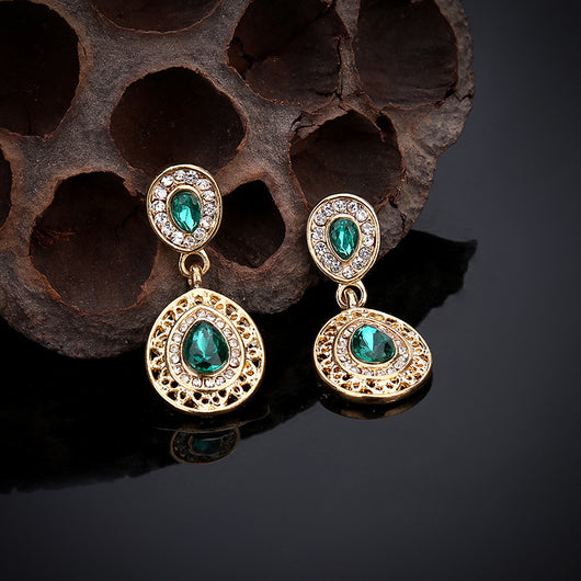 Gold-toned necklace and matching drop earrings set with blue teardrop crystals and clear rhinestones, on a wooden box. - Image 22