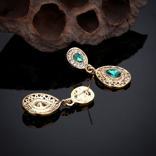 Gold-toned necklace and matching drop earrings set with blue teardrop crystals and clear rhinestones, on a wooden box. - Image 23