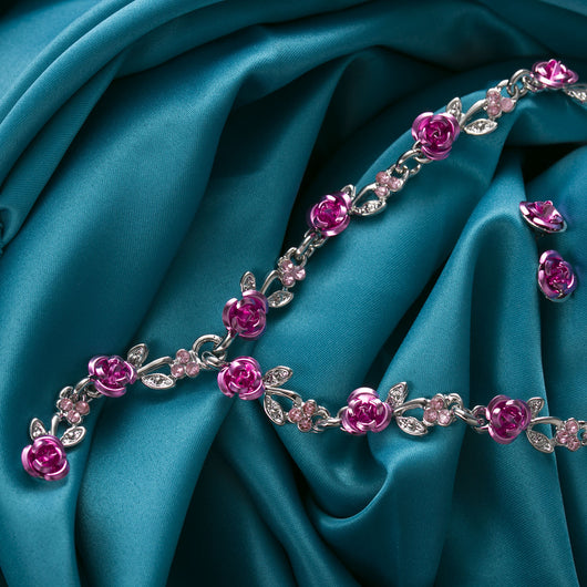 Red rose alloy necklace and stud earrings set with silver-tone chain and clear accents, displayed on a black bust. - Image 14