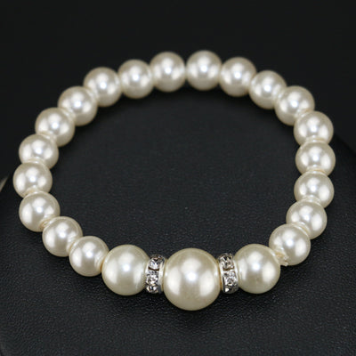 Three-piece cream faux pearl jewelry set with rhinestone accents, including a necklace, bracelet, and drop earrings. - Image 3