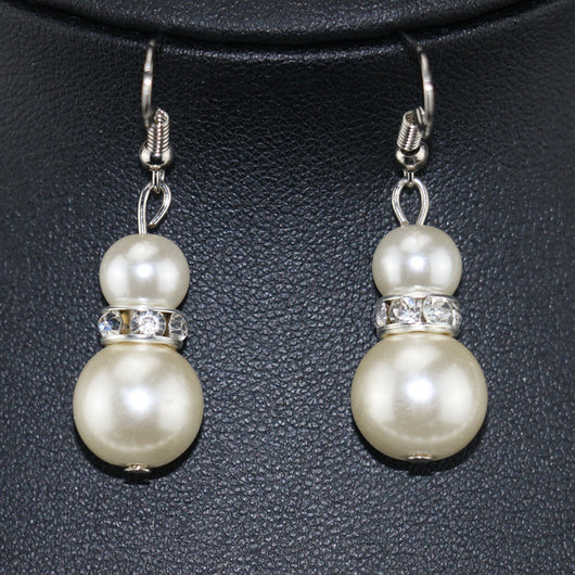 Three-piece cream faux pearl jewelry set with rhinestone accents, including a necklace, bracelet, and drop earrings. - Image 4