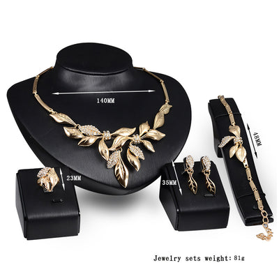 Gold-toned four-piece bridal wedding jewelry set with leaf design and clear rhinestones, including necklace, earrings, bracelet, and ring. - Image 4