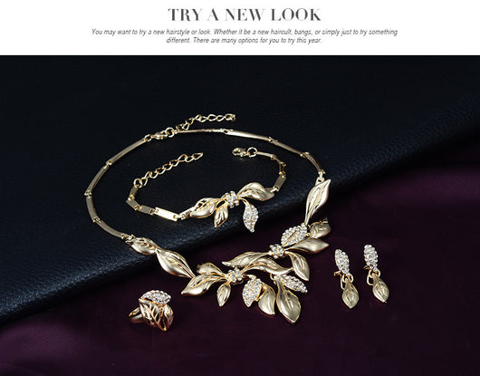 Gold-toned four-piece bridal wedding jewelry set with leaf design and clear rhinestones, including necklace, earrings, bracelet, and ring. - Image 5