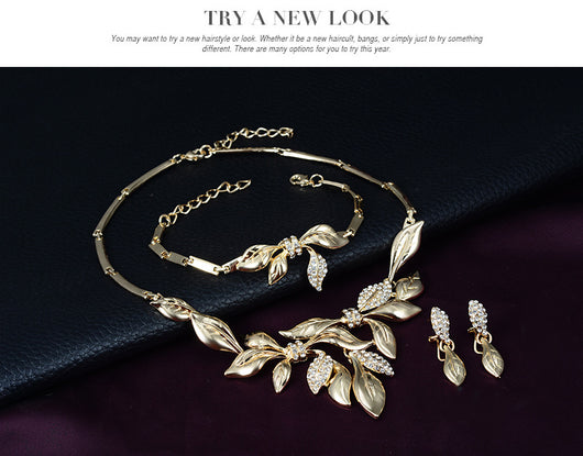 Gold-toned four-piece bridal wedding jewelry set with leaf design and clear rhinestones, including necklace, earrings, bracelet, and ring. - Image 6