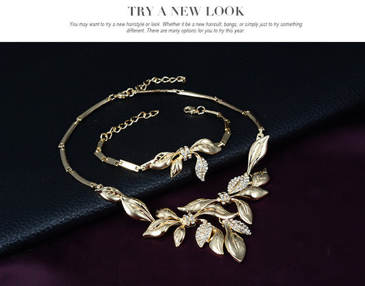Gold-toned four-piece bridal wedding jewelry set with leaf design and clear rhinestones, including necklace, earrings, bracelet, and ring. - Image 7