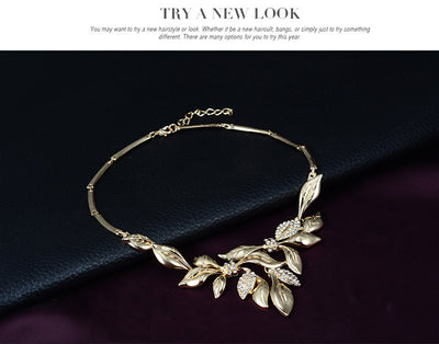 Gold-toned four-piece bridal wedding jewelry set with leaf design and clear rhinestones, including necklace, earrings, bracelet, and ring. - Image 8