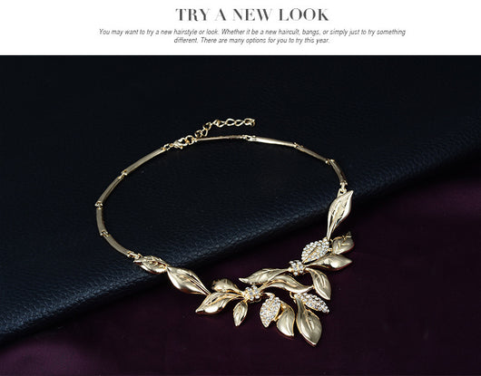 Gold-toned four-piece bridal wedding jewelry set with leaf design and clear rhinestones, including necklace, earrings, bracelet, and ring. - Image 8
