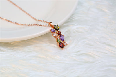 Shiny rose gold-tone necklace, earrings, and ring set with multi-colored teardrop and round zircon stones. Ring size 9. - Image 17