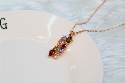 Shiny rose gold-tone necklace, earrings, and ring set with multi-colored teardrop and round zircon stones. Ring size 9. - Image 20