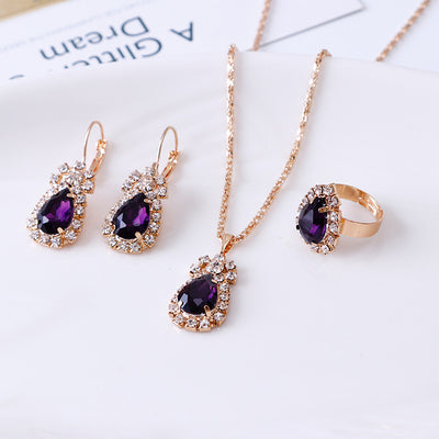 Red teardrop rhinestone necklace, matching dangle earrings, and adjustable ring set in gold-tone metal. - Image 8