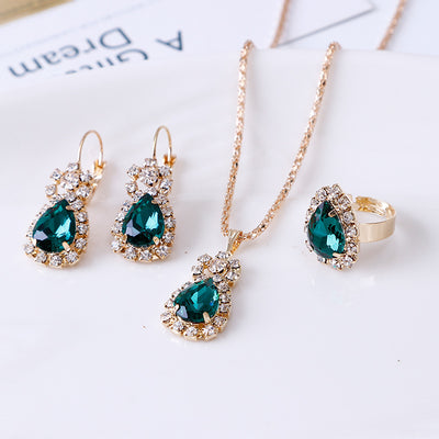 Red teardrop rhinestone necklace, matching dangle earrings, and adjustable ring set in gold-tone metal. - Image 9