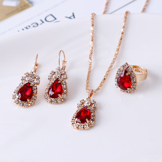Red teardrop rhinestone necklace, matching dangle earrings, and adjustable ring set in gold-tone metal. - Image 11