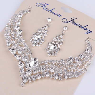 Sparkling silver-tone necklace and matching dangle earrings set, adorned with numerous clear crystals and large oval center stones. - Image 7