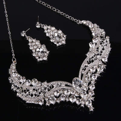 Sparkling silver-tone necklace and matching dangle earrings set, adorned with numerous clear crystals and large oval center stones. - Image 8