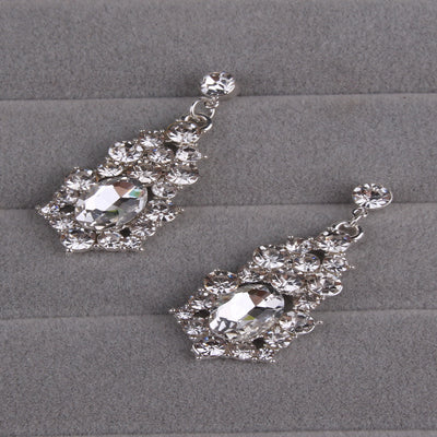 Sparkling silver-tone necklace and matching dangle earrings set, adorned with numerous clear crystals and large oval center stones. - Image 10