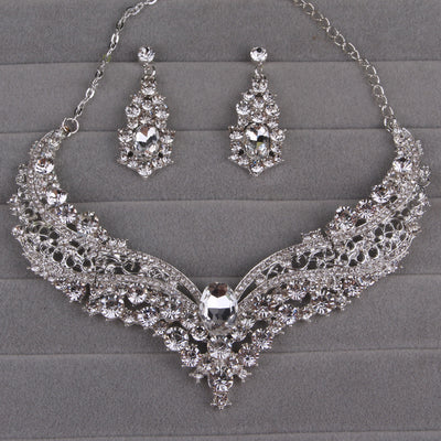 Sparkling silver-tone necklace and matching dangle earrings set, adorned with numerous clear crystals and large oval center stones. - Image 12