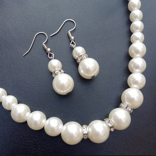 Three-piece white faux pearl jewelry set with rhinestone accents, including a necklace, drop earrings, and a bracelet. - Image 5