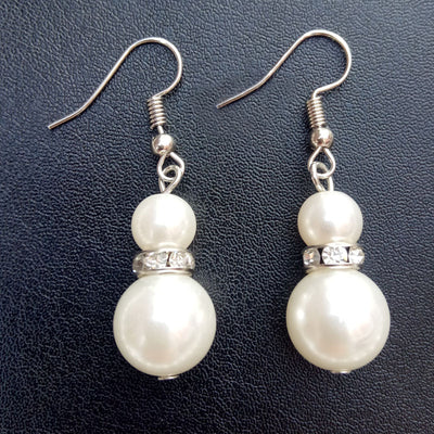 Three-piece white faux pearl jewelry set with rhinestone accents, including a necklace, drop earrings, and a bracelet. - Image 9