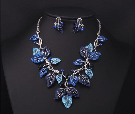 Blue enamel leaf necklace and matching earrings set with silver-tone vines and sparkling rhinestones, displayed on a black mannequin. - Image 7
