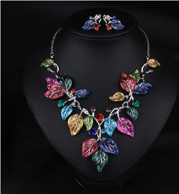 Blue enamel leaf necklace and matching earrings set with silver-tone vines and sparkling rhinestones, displayed on a black mannequin. - Image 8