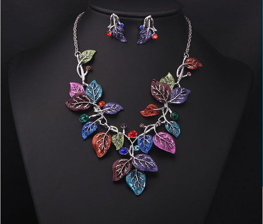 Blue enamel leaf necklace and matching earrings set with silver-tone vines and sparkling rhinestones, displayed on a black mannequin. - Image 10