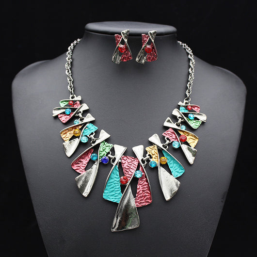 Silver and blue abstract fashion necklace and matching stud earrings set with blue rhinestones on a black mannequin. - Image 9