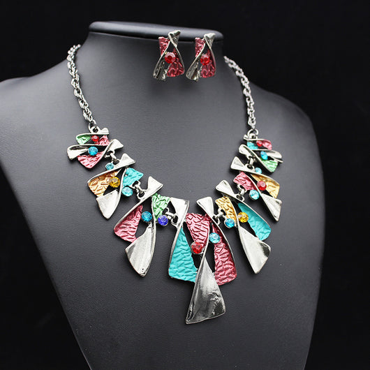 Silver and blue abstract fashion necklace and matching stud earrings set with blue rhinestones on a black mannequin. - Image 10