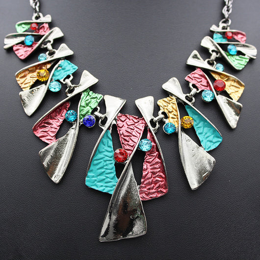 Silver and blue abstract fashion necklace and matching stud earrings set with blue rhinestones on a black mannequin. - Image 11