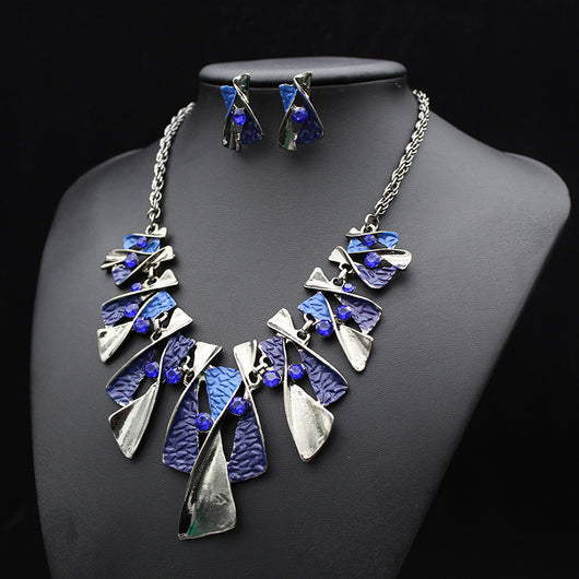 Silver and blue abstract fashion necklace and matching stud earrings set with blue rhinestones on a black mannequin. - Image 15