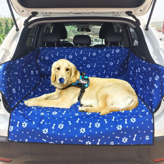Blue waterproof pet car mat with white paw print and bone patterns installed in the trunk of a white SUV. - Image 6