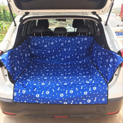 Blue waterproof pet car mat with white paw print and bone patterns installed in the trunk of a white SUV. - Image 7