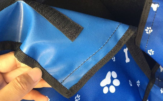 Blue waterproof pet car mat with white paw print and bone patterns installed in the trunk of a white SUV. - Image 11