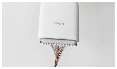 Black cordless hair shaver with a comb attachment and two white indicator lights, with a blurred white shaver in the background. - Image 11