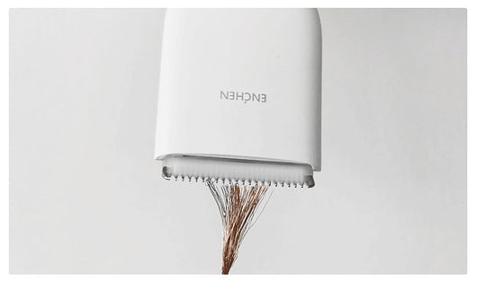 Black cordless hair shaver with a comb attachment and two white indicator lights, with a blurred white shaver in the background. - Image 11