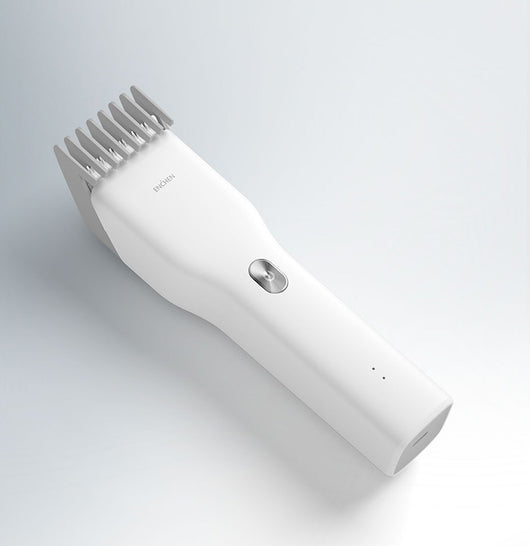 Black cordless hair shaver with a comb attachment and two white indicator lights, with a blurred white shaver in the background. - Image 13