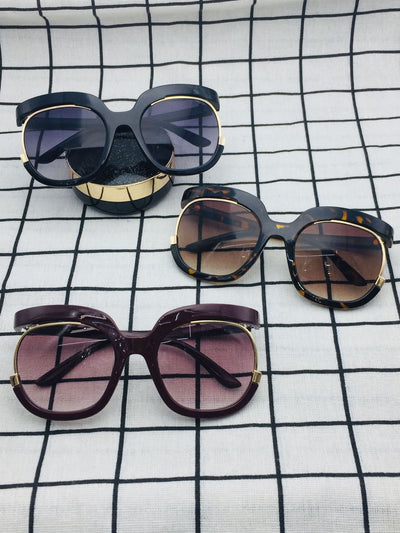 Black cat-eye half-frame sunglasses with gold accents and purple-grey gradient lenses, shown from front and side. - Image 5