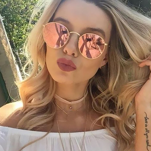 Round metallic sunglasses with iridescent green and gold lenses and a gold-colored metal frame. - Image 13