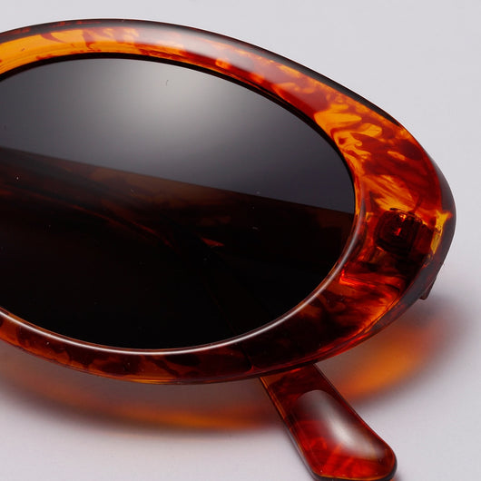 Translucent blue small frame oval sunglasses with light blue lenses on a white background. - Image 12